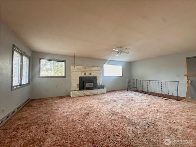 724 Hanford St, Omak, WA 98841 - unfurnished living room with carpet flooring, a ceiling fan, and baseboard heating