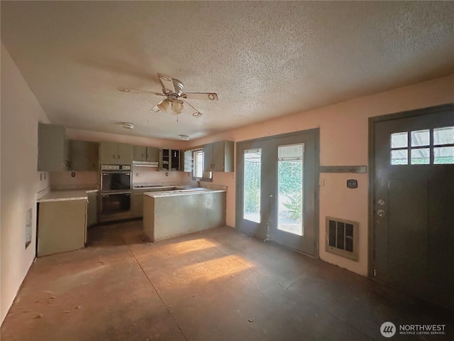 724 Hanford St, Omak, WA 98841 - kitchen with double wall oven, a peninsula, electric stovetop, a textured ceiling, and light countertops