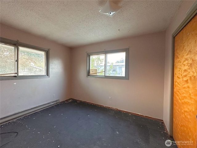 724 Hanford St, Omak, WA 98841 - empty room with a textured ceiling and baseboard heating
