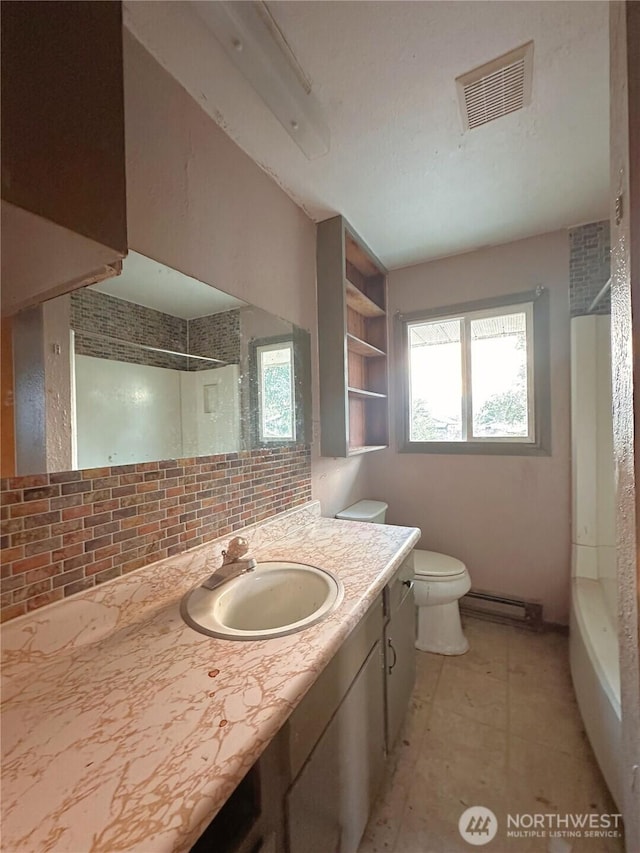 724 Hanford St, Omak, WA 98841 - bathroom featuring vanity, shower / bath combination, tasteful backsplash, and baseboard heating