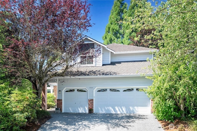 15101 91st Pl NE, Bothell, WA 98011 - view of front of home with asphalt driveway, a garage, brick siding, and a shingled roof