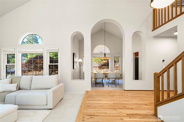 15101 91st Pl NE, Bothell, WA 98011 - living room featuring high vaulted ceiling, stairs, and wood finished floors