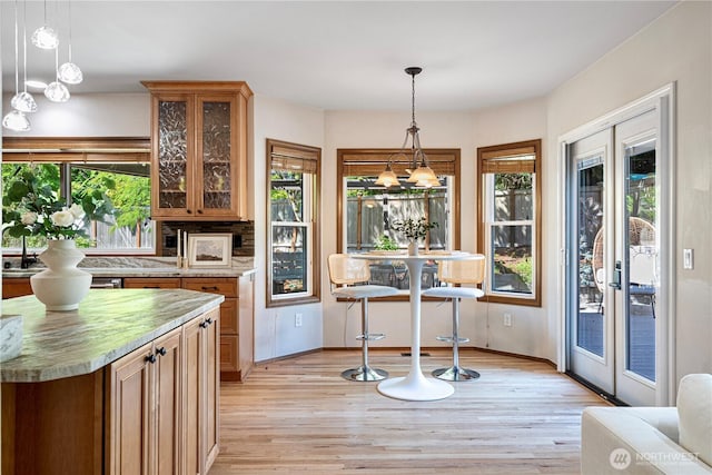 15101 91st Pl NE, Bothell, WA 98011 - kitchen featuring light wood-style floors, healthy amount of natural light, french doors, and glass insert cabinets