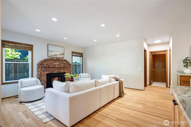 15101 91st Pl NE, Bothell, WA 98011 - living room with light wood finished floors, a fireplace, and recessed lighting