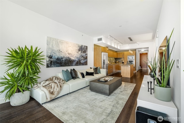 1920 4th Ave Unit 1207, Seattle, WA 98101 - living area featuring dark wood-type flooring and track lighting