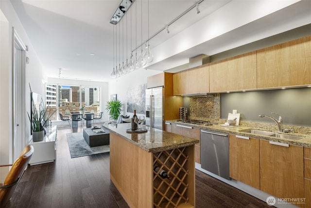 1920 4th Ave Unit 1207, Seattle, WA 98101 - kitchen featuring appliances with stainless steel finishes, stone counters, modern cabinets, backsplash, and a center island