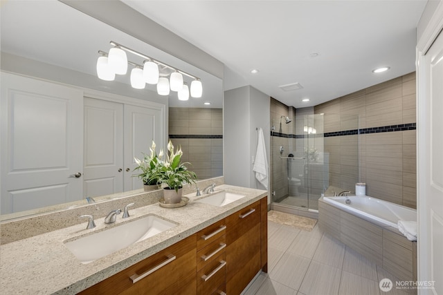 1920 4th Ave Unit 1207, Seattle, WA 98101 - bathroom featuring a shower stall, tile patterned flooring, double vanity, a bath, and recessed lighting