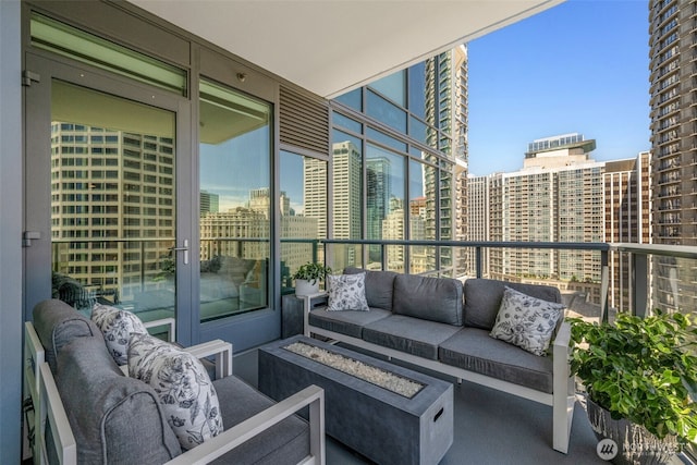 1920 4th Ave Unit 1207, Seattle, WA 98101 - balcony featuring an outdoor living space with a fire pit and a city view