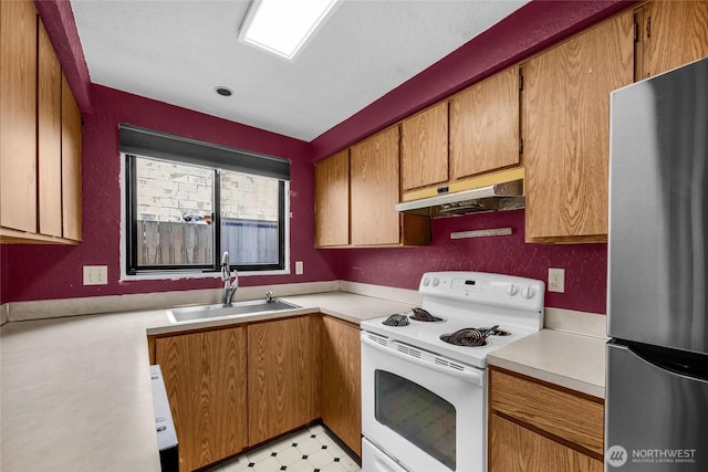 9404 Stone Ave N, Seattle, WA 98103 - kitchen featuring freestanding refrigerator, white electric stove, under cabinet range hood, and light countertops