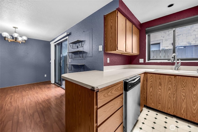 9404 Stone Ave N, Seattle, WA 98103 - kitchen with dishwasher, plenty of natural light, a textured wall, light floors, and a chandelier