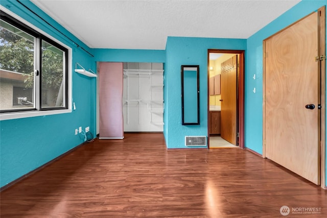 9404 Stone Ave N, Seattle, WA 98103 - unfurnished bedroom featuring wood finished floors, a closet, and a textured ceiling