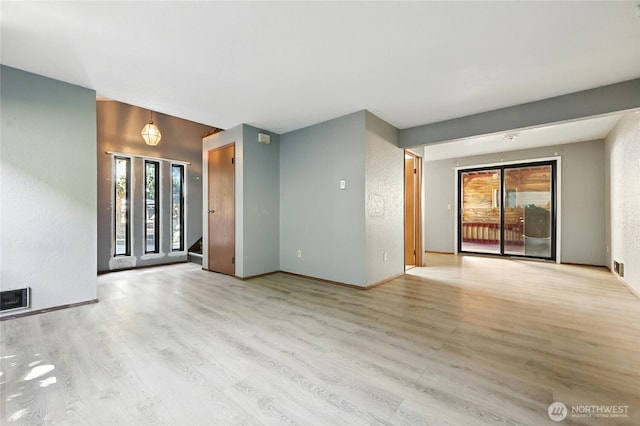 9404 Stone Ave N, Seattle, WA 98103 - unfurnished living room with wood finished floors and baseboards