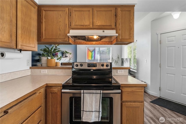 1949 S Sheridan Ave, Tacoma, WA 98405 - kitchen featuring stainless steel electric range oven, under cabinet range hood, light countertops, and wood finished floors