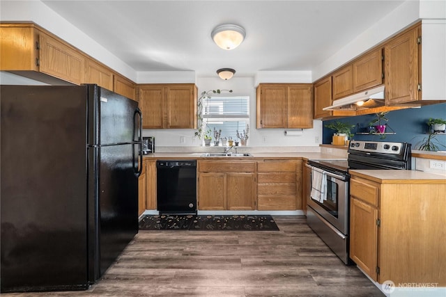 1949 S Sheridan Ave, Tacoma, WA 98405 - kitchen with black appliances, under cabinet range hood, light countertops, and dark wood-style floors