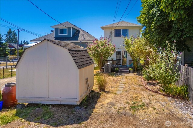 1949 S Sheridan Ave, Tacoma, WA 98405 - back of house with a storage unit and a deck