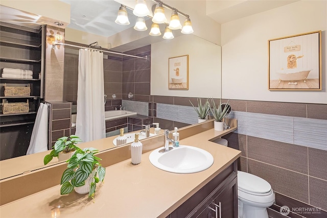 530 4th Ave W Unit 405, Seattle, WA 98119 - bathroom with vanity, tiled shower / bath combo, and tile walls