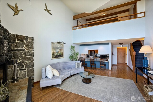 140 Admiralty Ln Unit 370, Port Ludlow, WA 98365 - living room featuring high vaulted ceiling, stairway, wood finished floors, and a fireplace