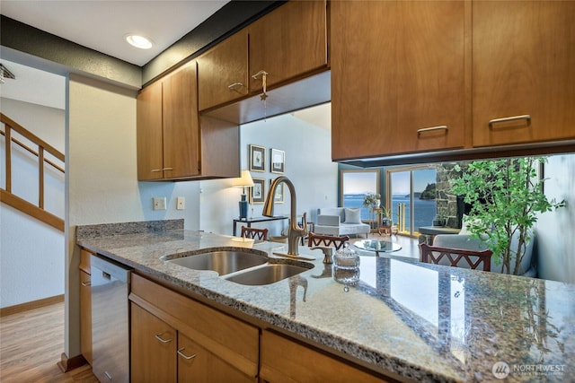 140 Admiralty Ln Unit 370, Port Ludlow, WA 98365 - kitchen with dishwasher, wood finished floors, light stone countertops, a water view, and brown cabinetry