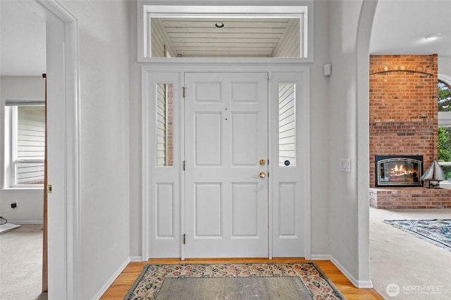 4015 E Broadway St, Mount Vernon, WA 98274 - foyer featuring a fireplace, arched walkways, and light wood-type flooring