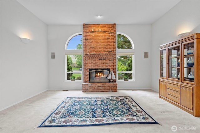 4015 E Broadway St, Mount Vernon, WA 98274 - unfurnished living room with carpet flooring, healthy amount of natural light, and a fireplace
