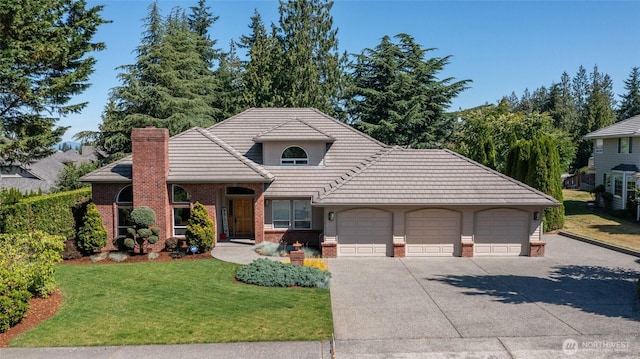 4015 E Broadway St, Mount Vernon, WA 98274 - view of front facade featuring brick siding, a front lawn, driveway, an attached garage, and a tiled roof