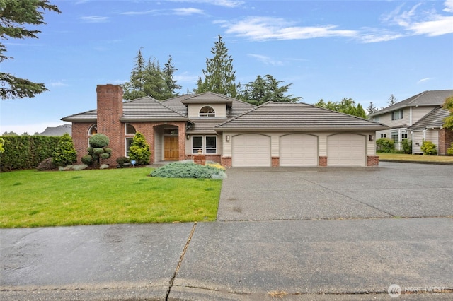 4015 E Broadway St, Mount Vernon, WA 98274 - view of front of home featuring brick siding, a front yard, concrete driveway, a garage, and a chimney