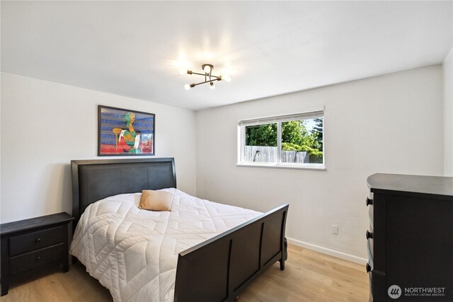 2426 Haines St, Port Townsend, WA 98368 - bedroom with light wood-style floors and a chandelier