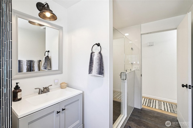 2426 Haines St, Port Townsend, WA 98368 - bathroom with a shower stall, wood finished floors, and vanity