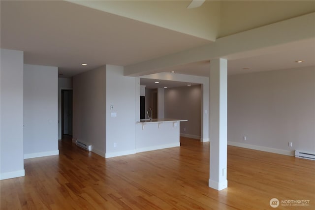 181 N Bay Ln Unit 2, Port Ludlow, WA 98165 - unfurnished living room with light wood-style floors, recessed lighting, and a baseboard heating unit