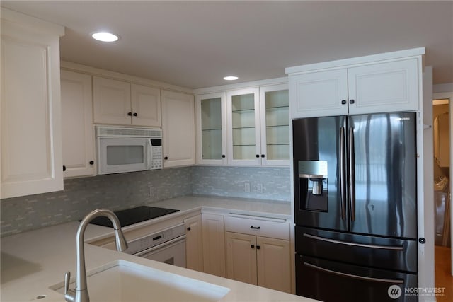 181 N Bay Ln Unit 2, Port Ludlow, WA 98165 - kitchen featuring white appliances, white cabinets, light countertops, backsplash, and recessed lighting