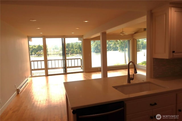 181 N Bay Ln Unit 2, Port Ludlow, WA 98165 - kitchen with baseboard heating, dishwashing machine, healthy amount of natural light, light wood-style floors, and recessed lighting