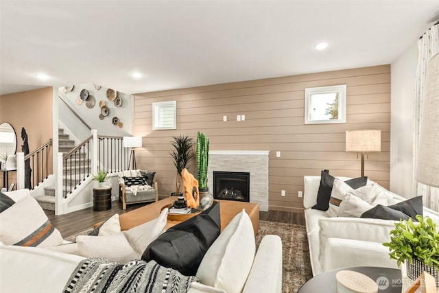 32324 135th Pl SE Unit 211, Sultan, WA 98294 - living room with wood finished floors, stairs, a tile fireplace, recessed lighting, and wooden walls
