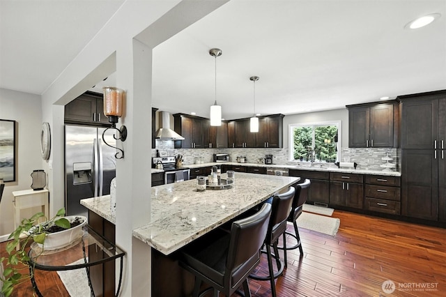 7212 188th Ave E, Bonney Lake, WA 98391 - kitchen with stainless steel appliances, dark wood-type flooring, a kitchen island, backsplash, and recessed lighting