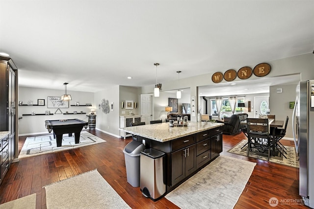 7212 188th Ave E, Bonney Lake, WA 98391 - kitchen with freestanding refrigerator, open floor plan, a kitchen island, dark wood-type flooring, and billiards