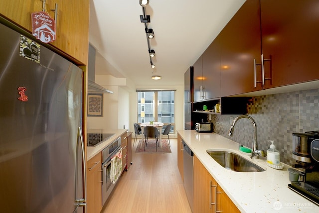 500 5th Ave W Unit 505, Seattle, WA 98119 - kitchen featuring stainless steel appliances, tasteful backsplash, light wood-style floors, modern cabinets, and track lighting