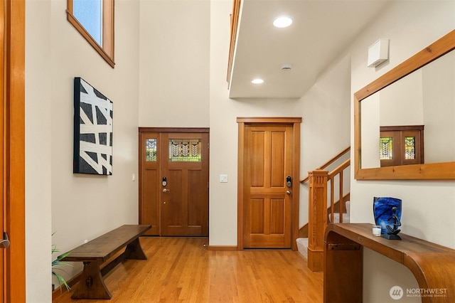 11226 NE 67th St, Kirkland, WA 98033 - foyer featuring light wood-type flooring, stairs, recessed lighting, and a towering ceiling