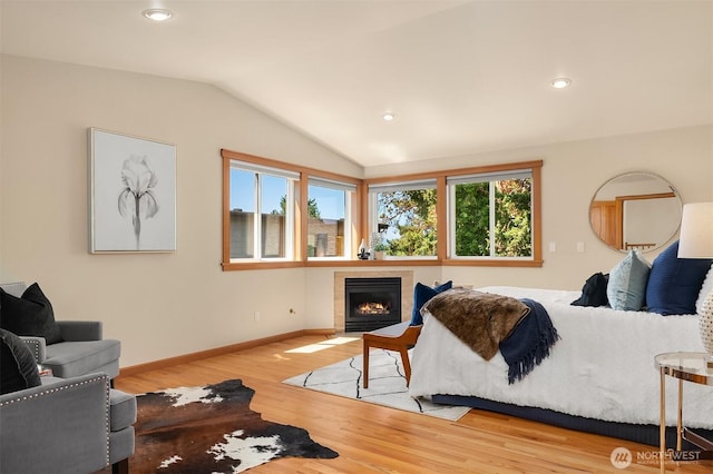 11226 NE 67th St, Kirkland, WA 98033 - bedroom featuring wood finished floors, lofted ceiling, a tile fireplace, and recessed lighting