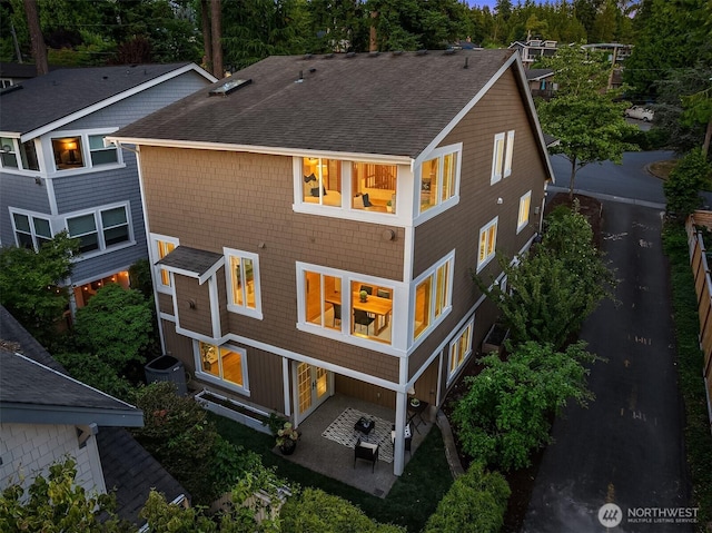 11226 NE 67th St, Kirkland, WA 98033 - back of house featuring a shingled roof, a patio, and view of scattered trees