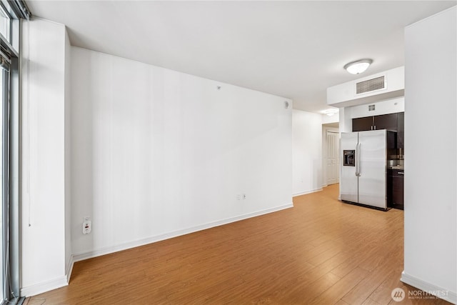 819 Virginia St Unit 2408, Seattle, WA 98101 - unfurnished living room featuring light wood-style flooring and baseboards