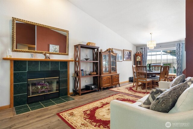 103 Nikula Rd W, Winlock, WA 98596 - living room with a chandelier, wood finished floors, lofted ceiling, and a fireplace