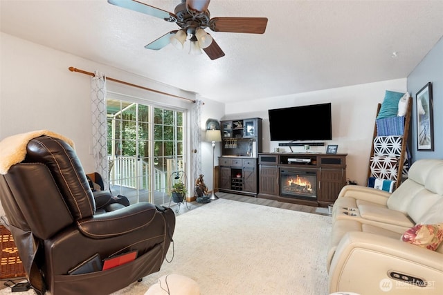 103 Nikula Rd W, Winlock, WA 98596 - living room with ceiling fan, a glass covered fireplace, and wood finished floors