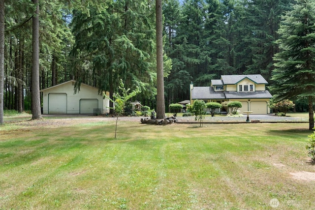 103 Nikula Rd W, Winlock, WA 98596 - view of green lawn featuring a garage, an outdoor structure, and a view of trees