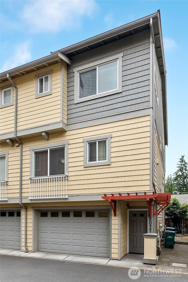 8077 165th Ln NE, Redmond, WA 98052 - rear view of property with an attached garage