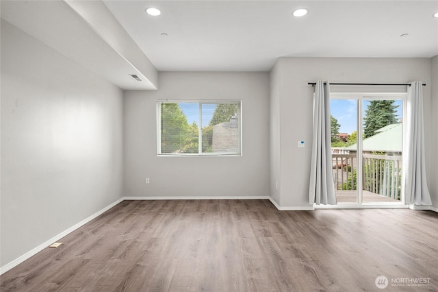 8077 165th Ln NE, Redmond, WA 98052 - spare room with healthy amount of natural light, wood finished floors, and recessed lighting
