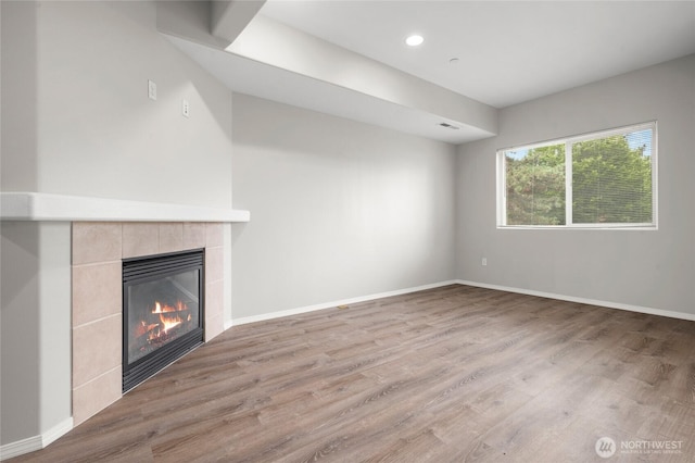 8077 165th Ln NE, Redmond, WA 98052 - unfurnished living room featuring a fireplace, wood finished floors, and recessed lighting