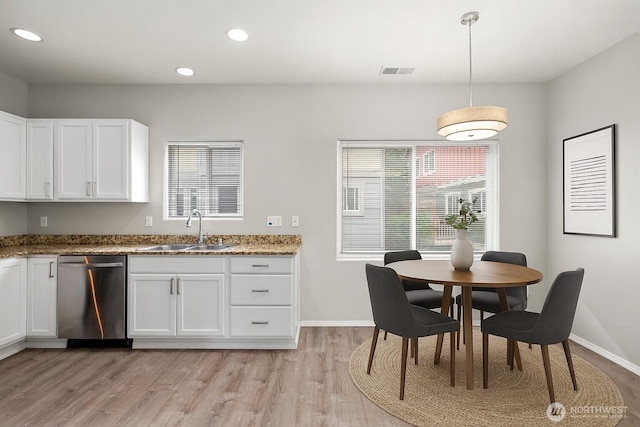 8077 165th Ln NE, Redmond, WA 98052 - kitchen featuring stainless steel dishwasher, white cabinets, stone counters, light wood-style floors, and recessed lighting