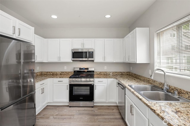 8077 165th Ln NE, Redmond, WA 98052 - kitchen featuring stainless steel appliances, white cabinetry, light wood-type flooring, recessed lighting, and light stone countertops