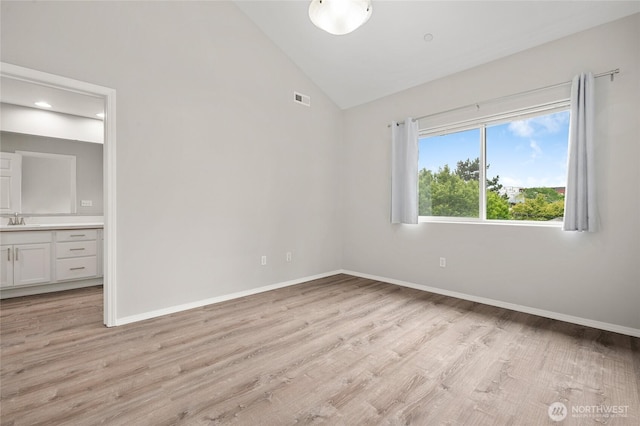 8077 165th Ln NE, Redmond, WA 98052 - unfurnished bedroom with lofted ceiling, light wood-style flooring, ensuite bath, and recessed lighting