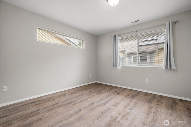 8077 165th Ln NE, Redmond, WA 98052 - empty room featuring wood finished floors and baseboards