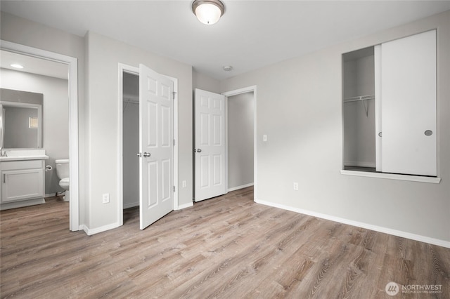 8077 165th Ln NE, Redmond, WA 98052 - unfurnished bedroom featuring light wood finished floors, ensuite bathroom, and a closet